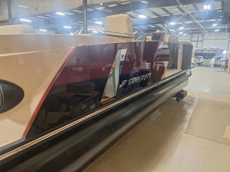 Completed two-tone pontoon boat on an indoor production line